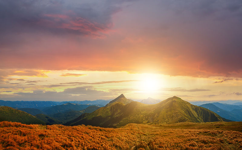 Imagen de portada de Qualitat Global: se muestra un paisaje donde es ven unas montañas y el sol en el horizonte.